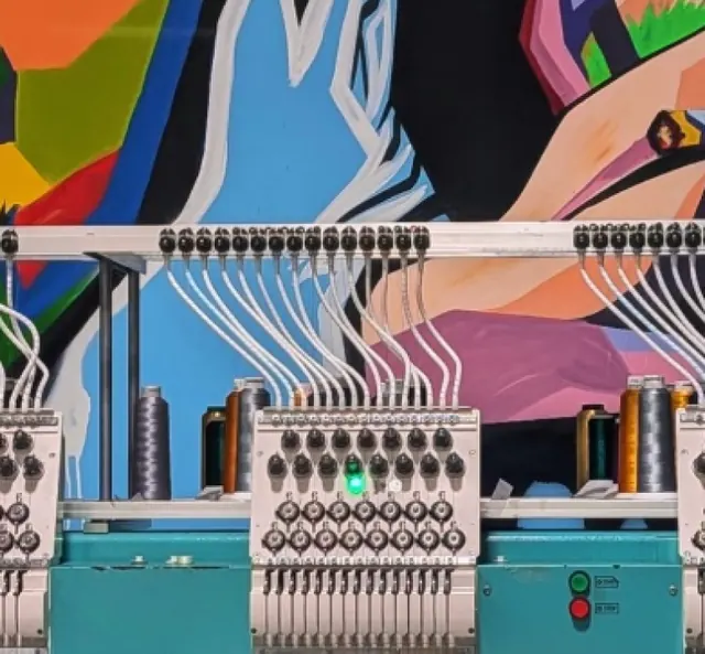 Embroidery machines under the Ripprint mural