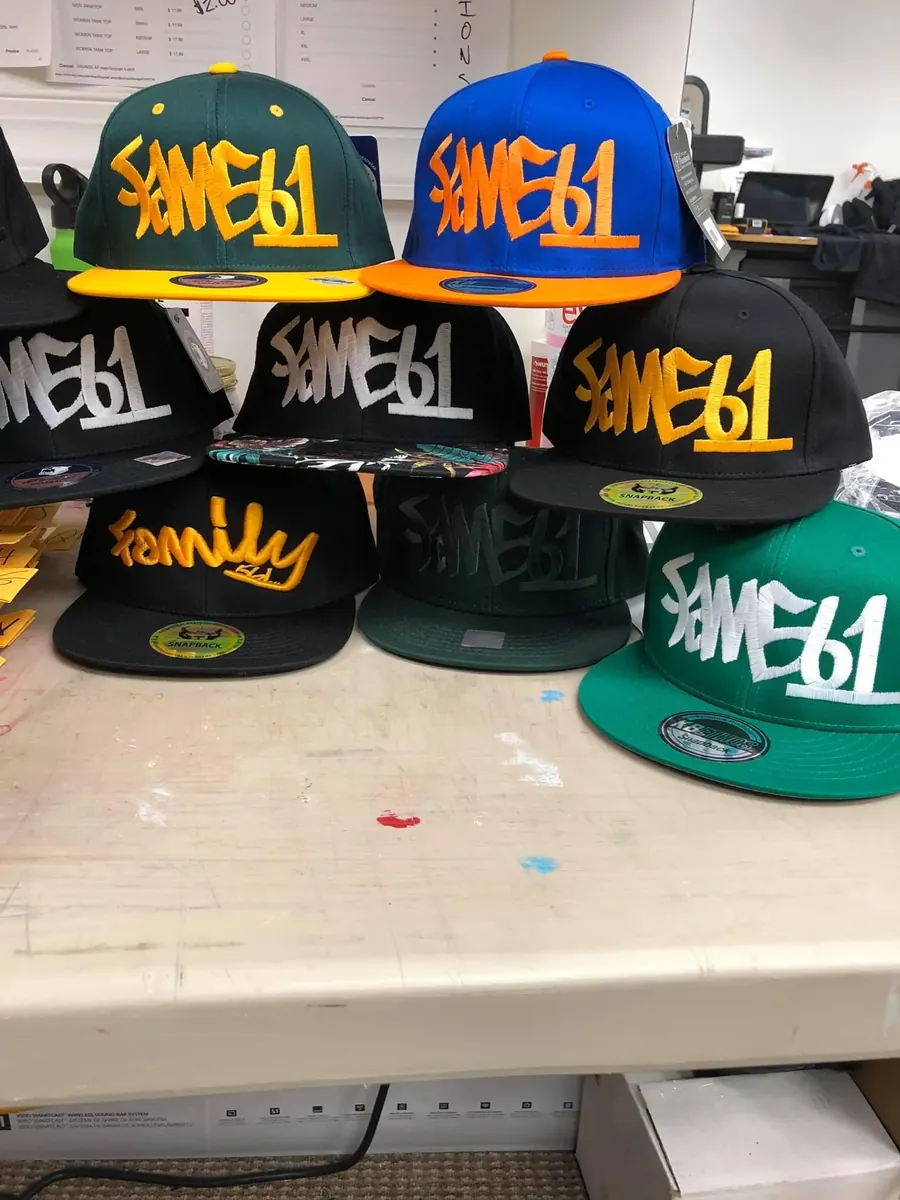Stack of embroidered snapback caps